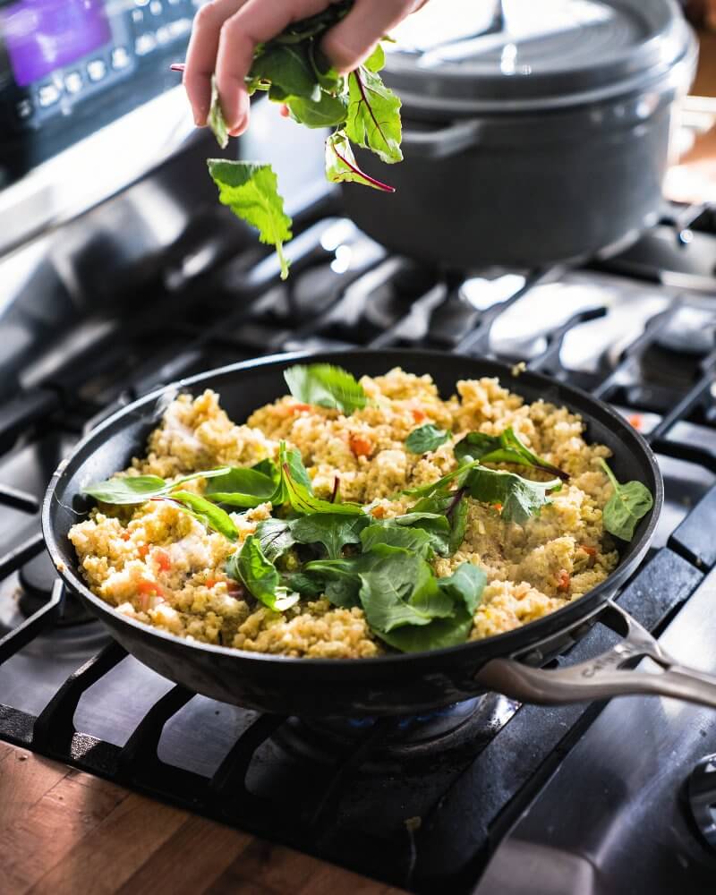 Greens going into pan on stove