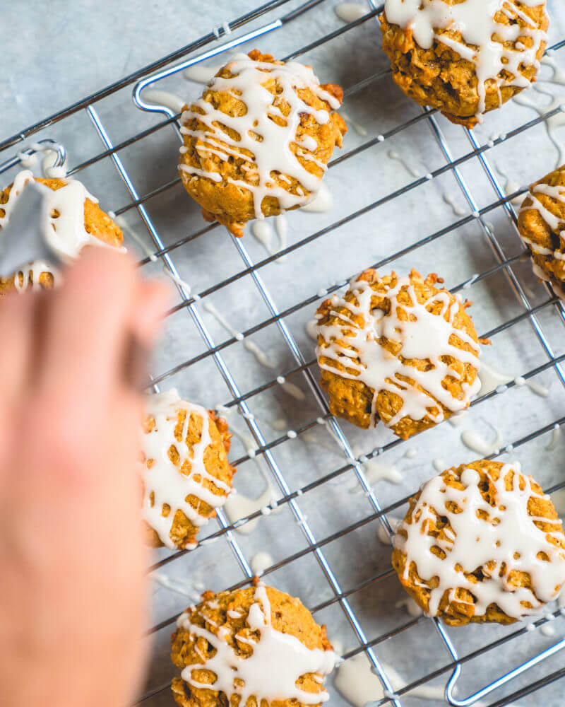Drizzling icing on vegan oatmeal cookies