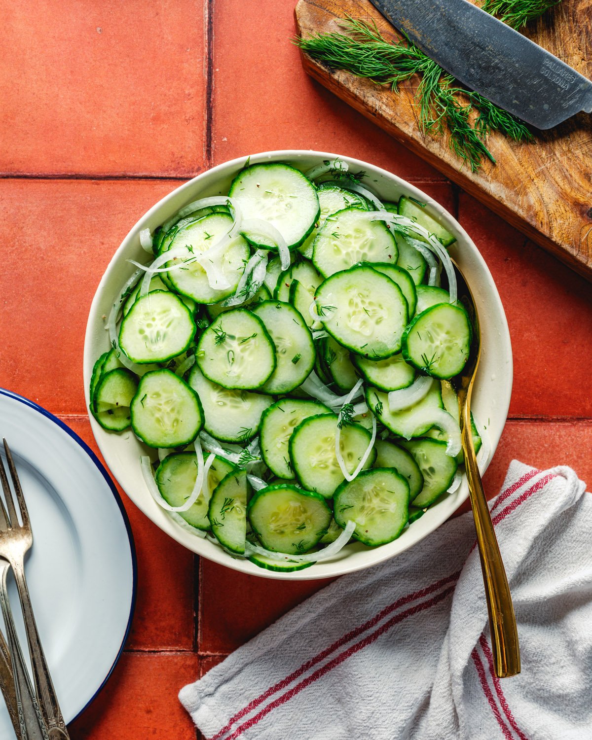 Cucumber salad with vinegar in bowl with dill. 