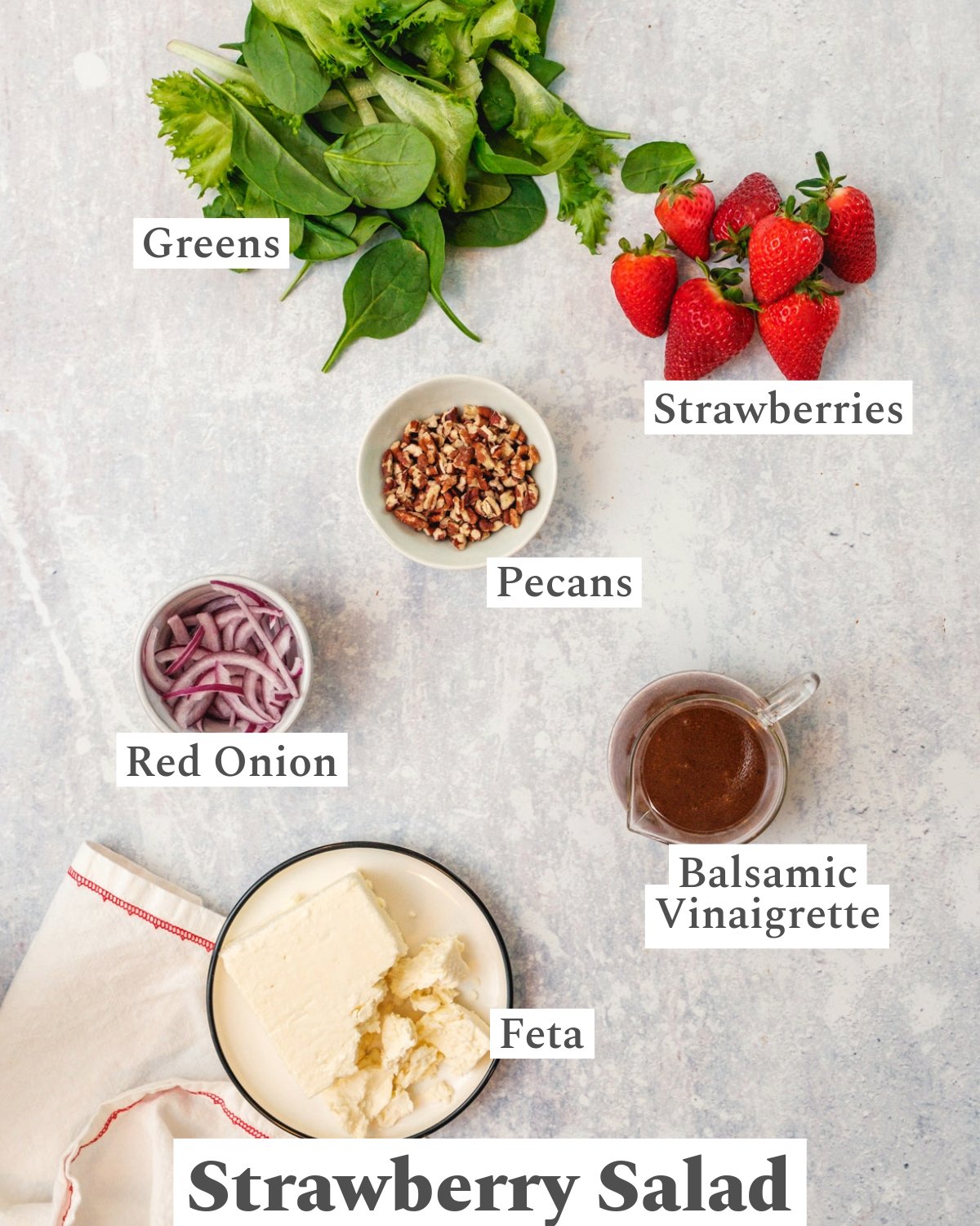 Ingredients in strawberry salad; Strawberries, greens, pecans, red onion, feta cheese, balsamic vinaigrette