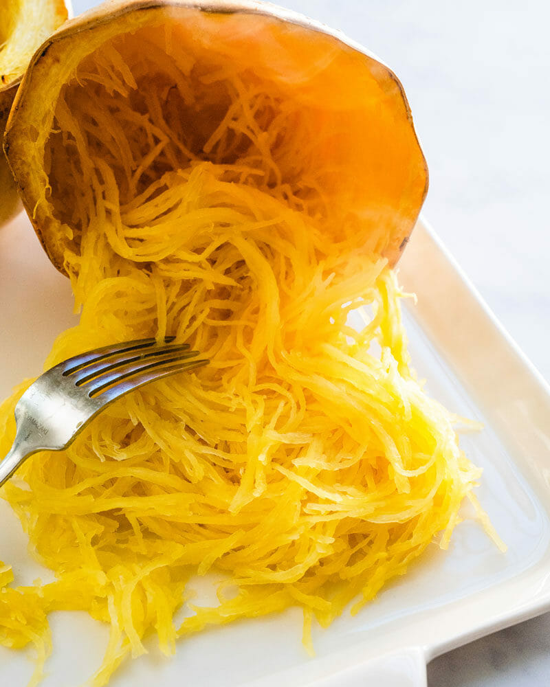 Scraping the spaghetti squash into strands