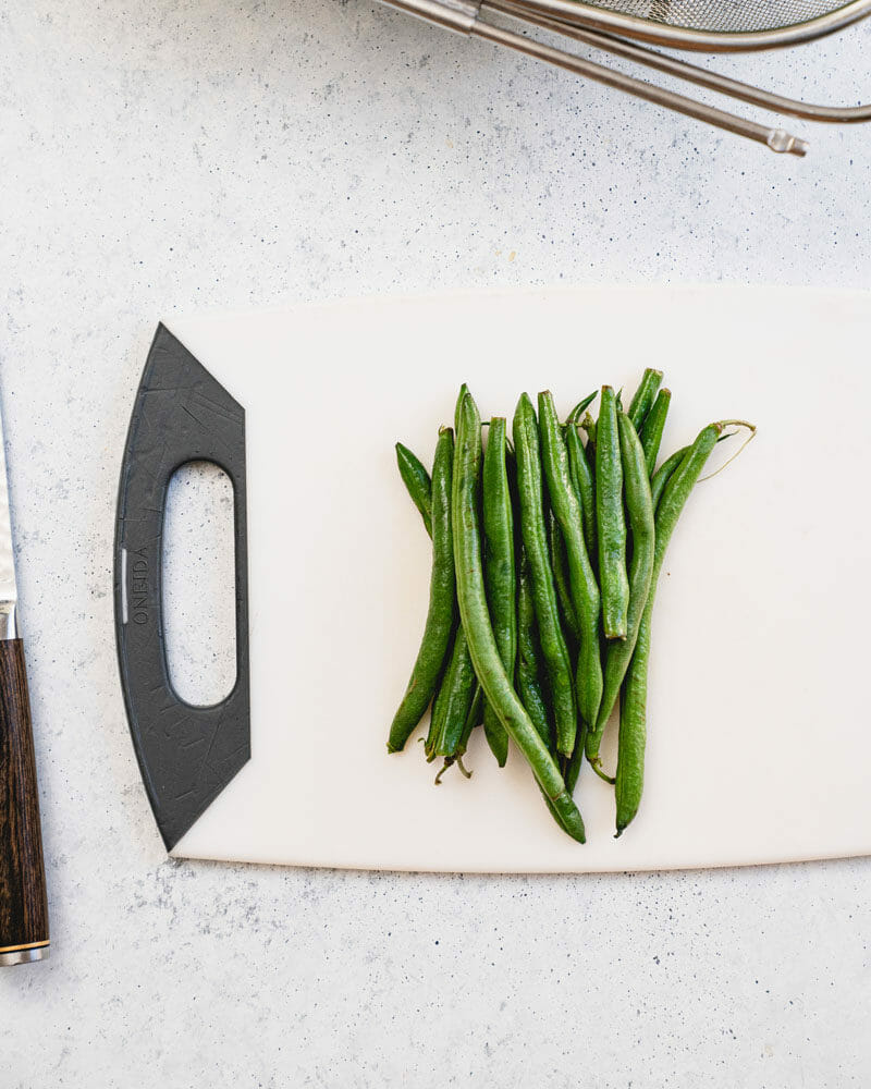 How to trim green beans: Grab a handful and place them in a pile