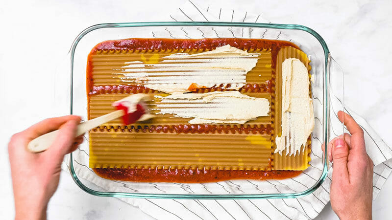 Layering dairy free lasagna