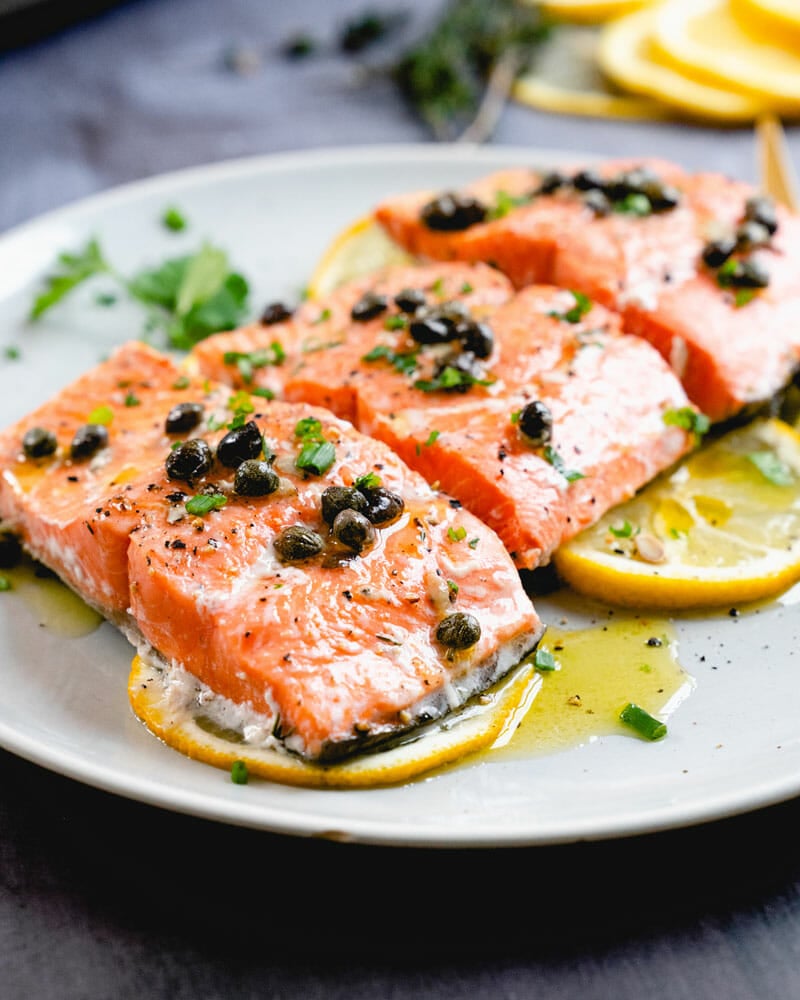 Salmon with capers and lemon on plate