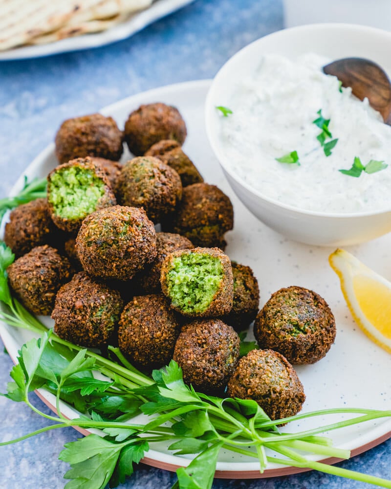 Falafel on plate with cucumber sauce in bowl