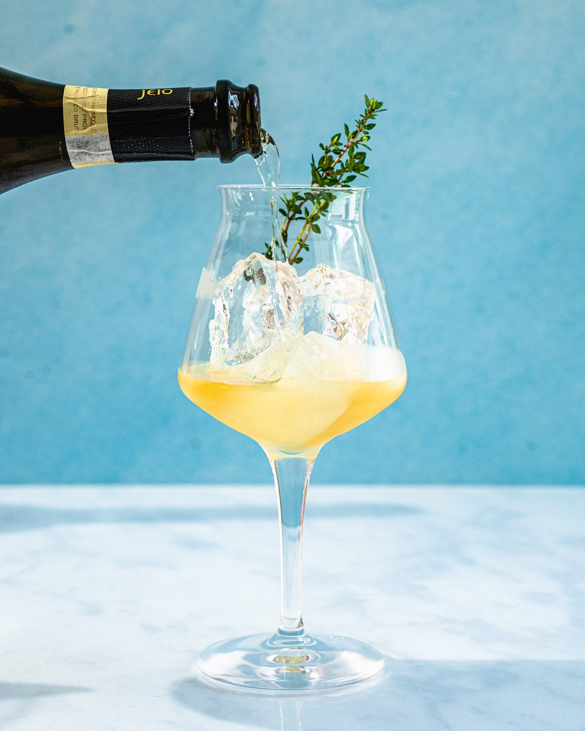 Champagne pouring into St Germain Spritz glass