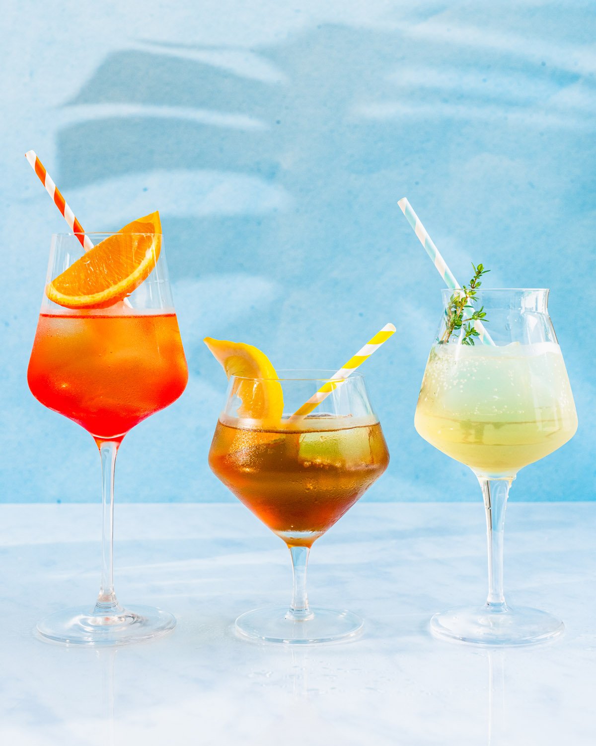 Spritz recipes in stemmed glasses: Campari spritz, amaro spritz, St Germain spritz