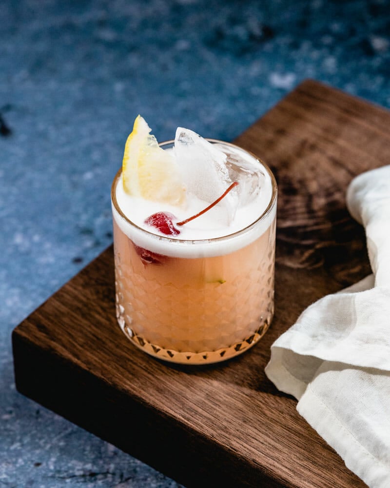 Vodka sour with egg white foam and cocktail cherry