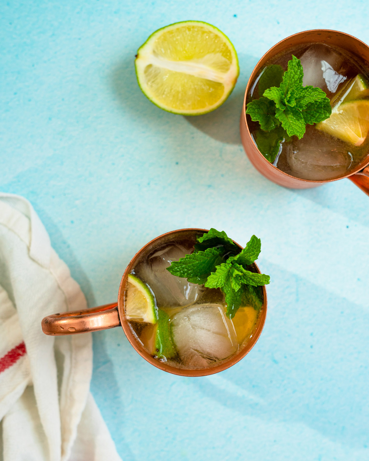 Mezcal mule in copper mug with lime and mint garnish.