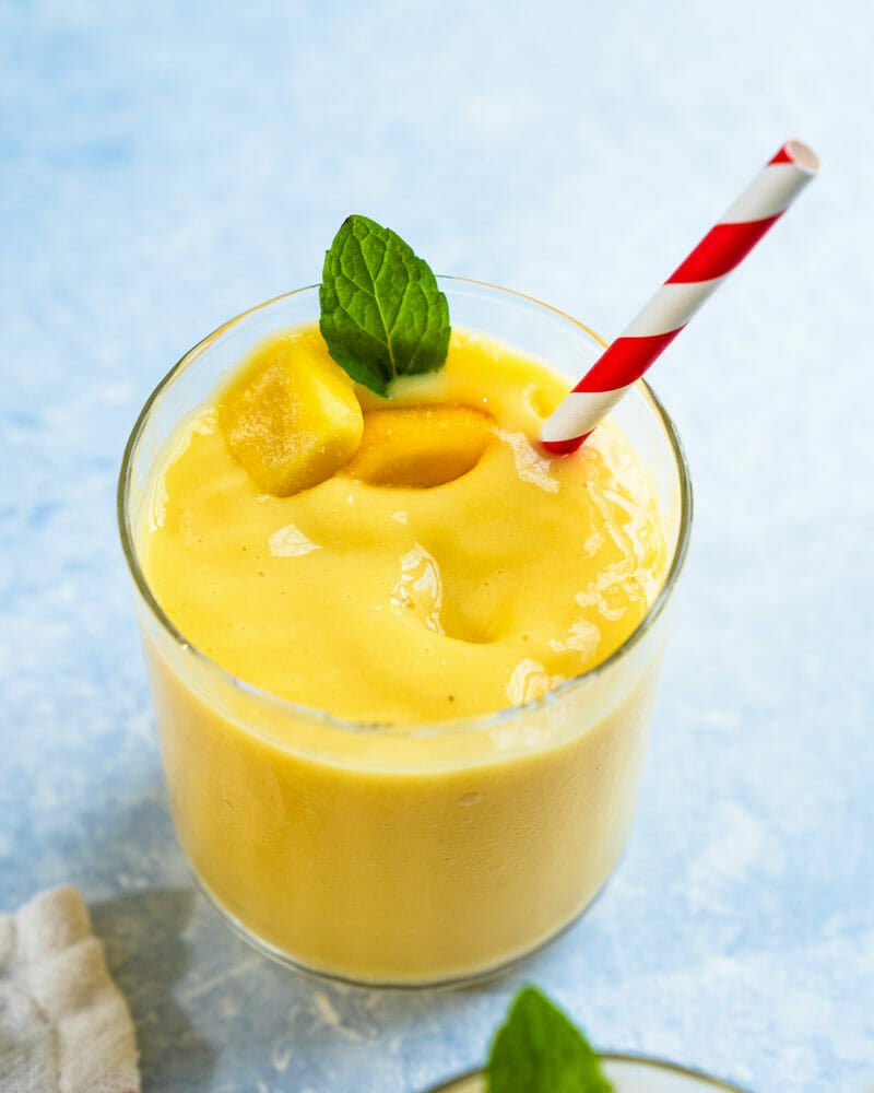 Mango smoothie with mint and straw