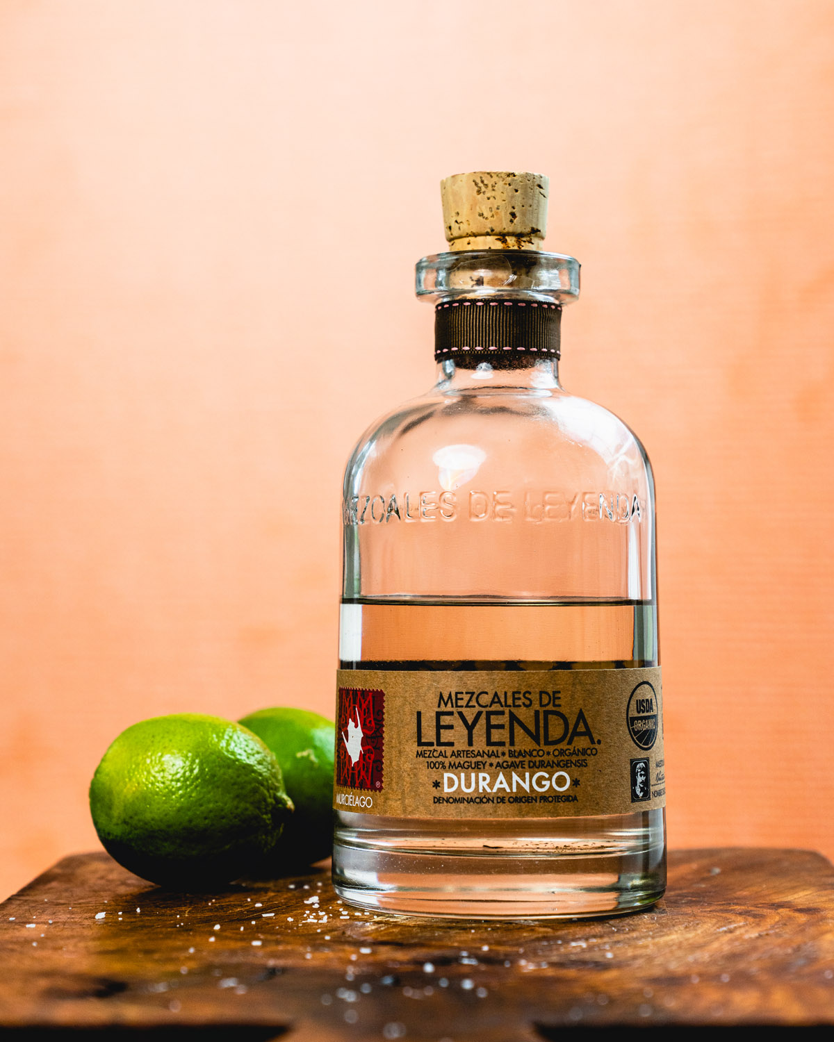 Mezcal bottle with limes. 