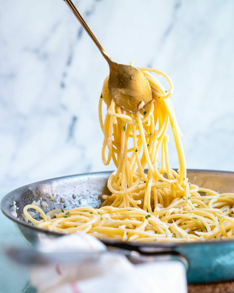White wine sauce on pasta in pan