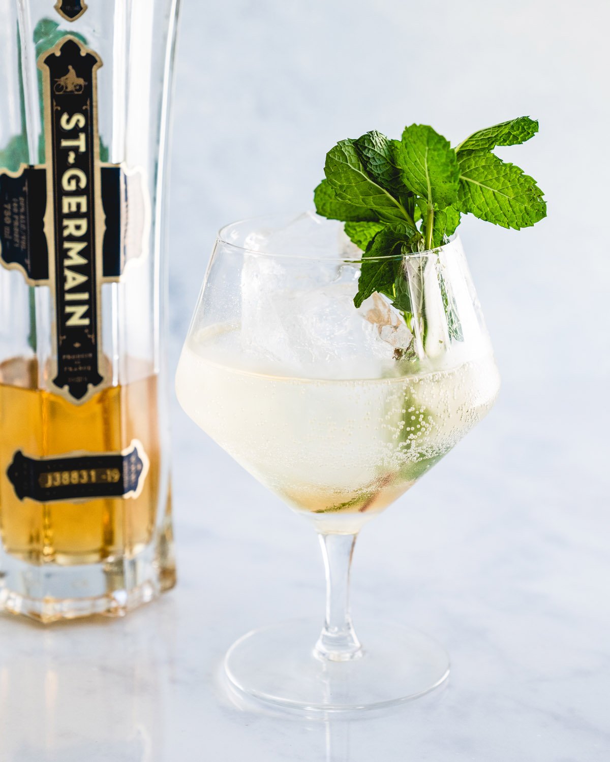 Hugo Spritz cocktail with St-Germain bottle.