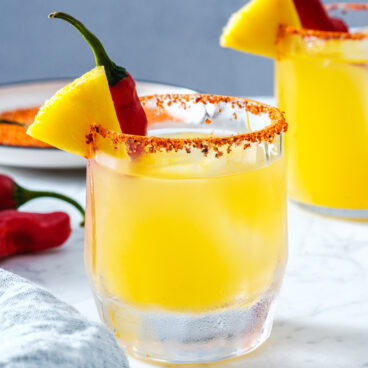Spicy Pineapple Margarita with Tajin rim and spicy pepper.