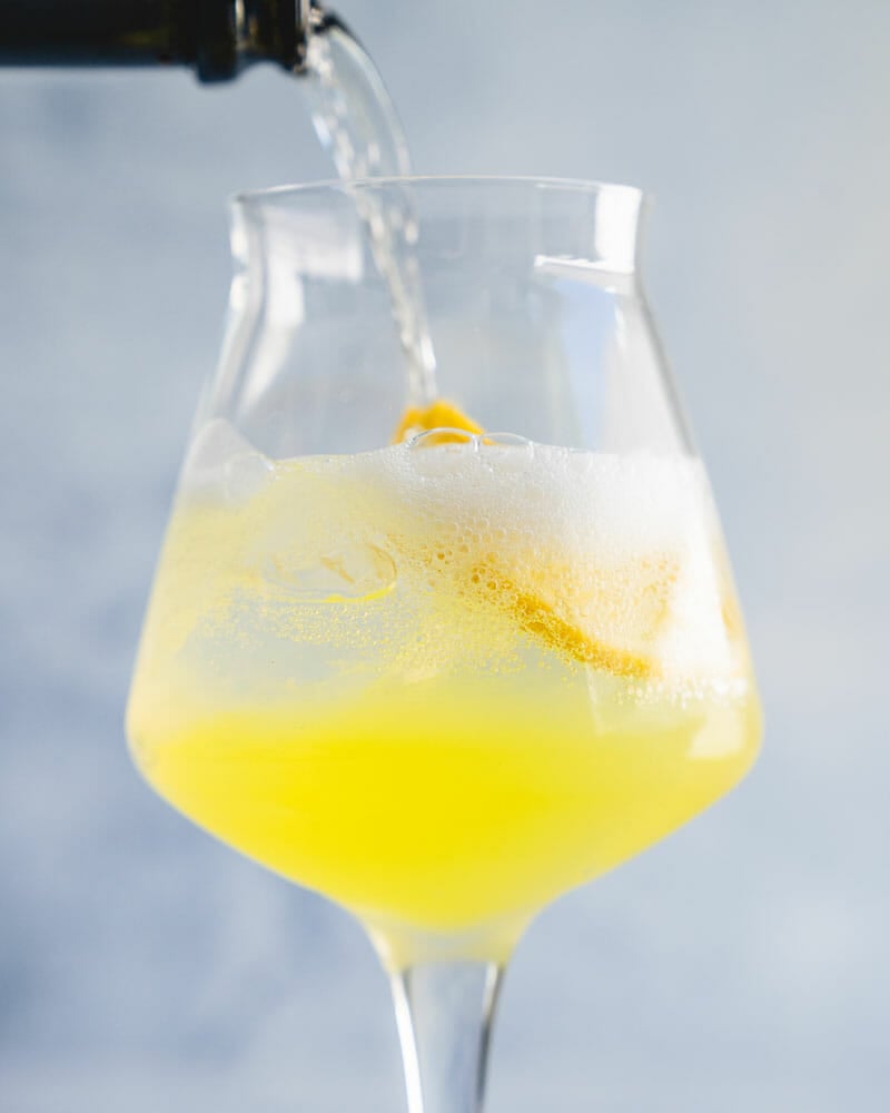 Step 1: Add the limoncello to a glass with ice. Add Prosecco and soda water.