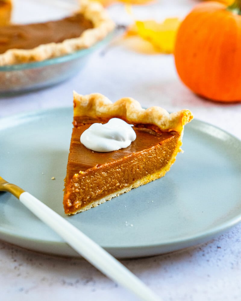 Vegan pumpkin pie on plate with fork