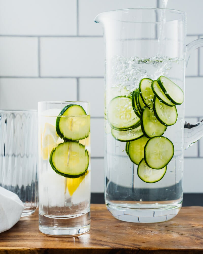 Cucumber water in glass and pitcher.
