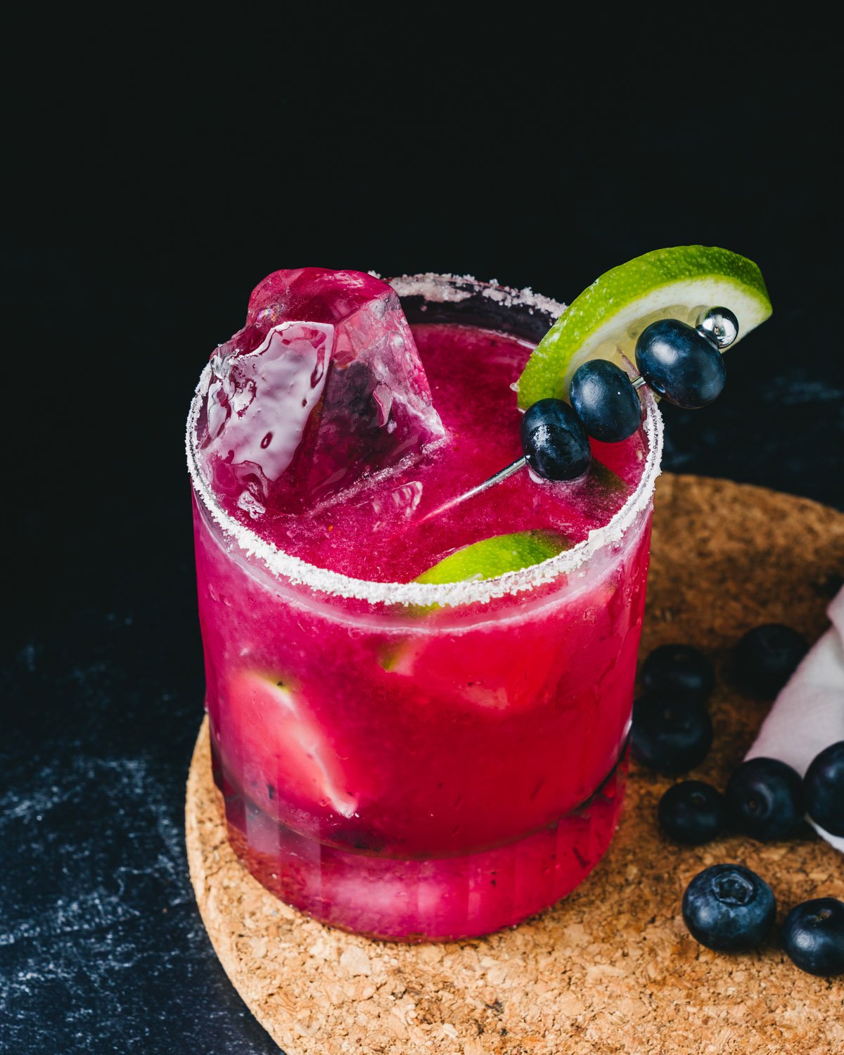 Blueberry Margarita in rocks class with clear ice.