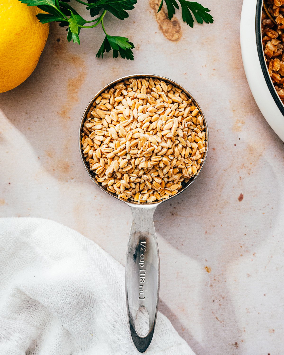 Uncooked farro in measuring cup