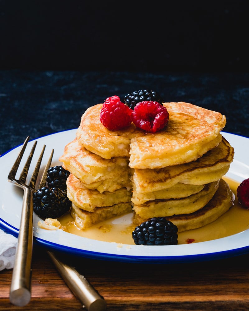 Stack of Cottage Cheese Pancakes with bite cut out showing texture. 