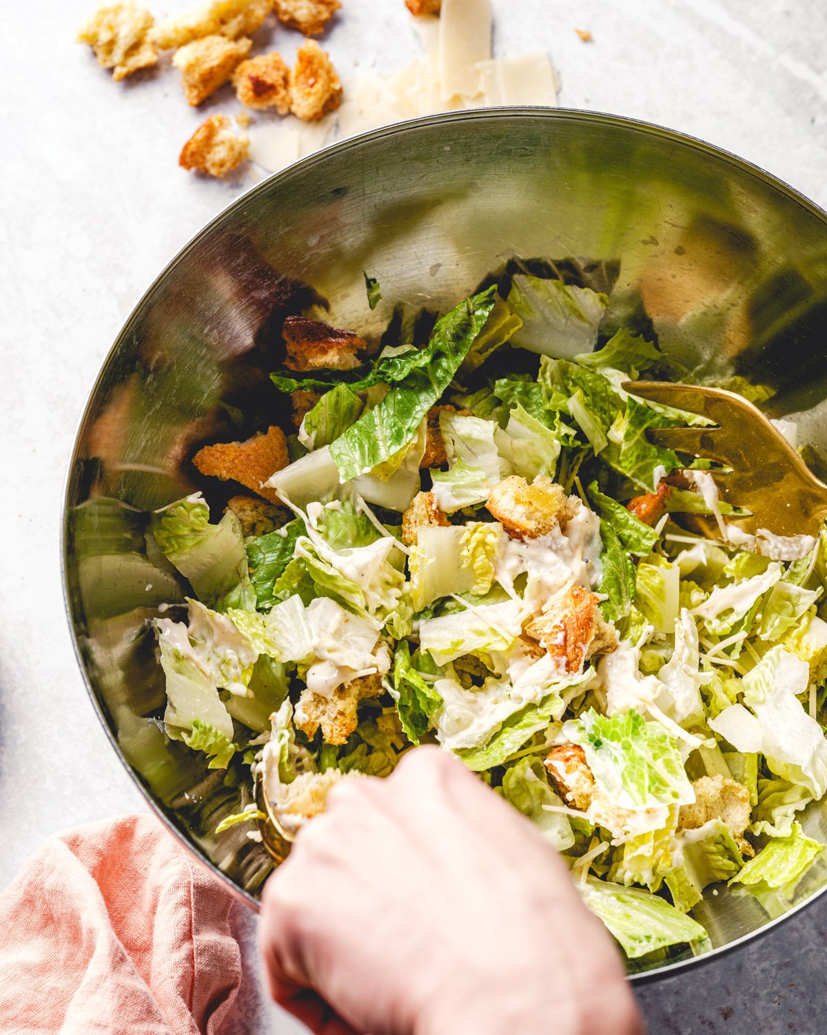 Toss the Caesar salad in a bowl.