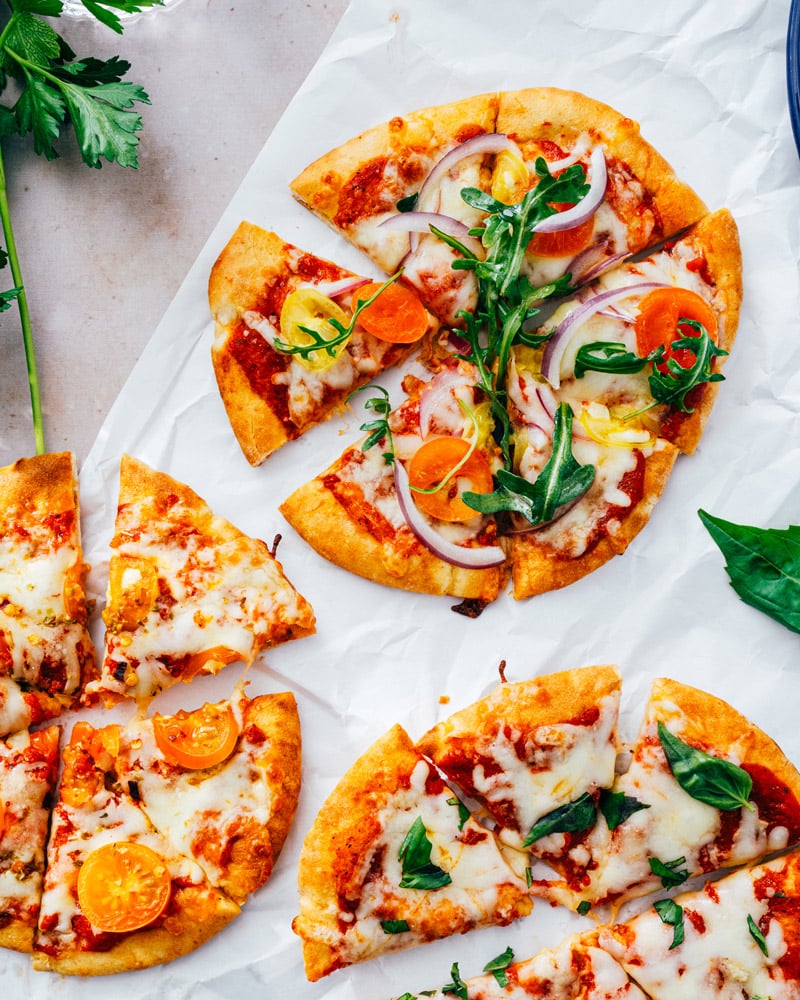 Pita Bread Pizza on table with different toppings