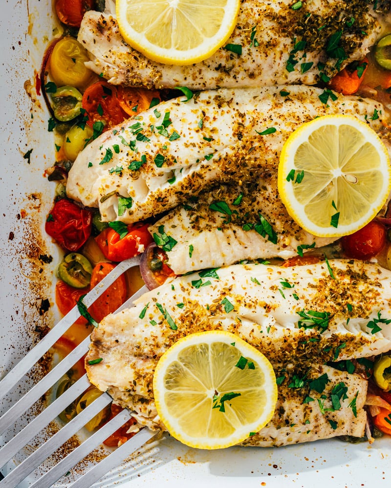Baked Fish with lemon and olives in pan