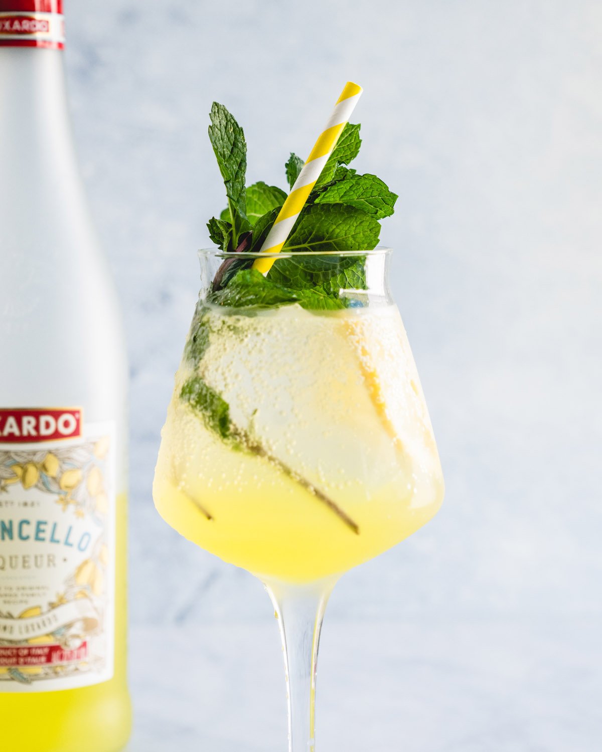 Limoncello spritz in stemmed glass with mint. 