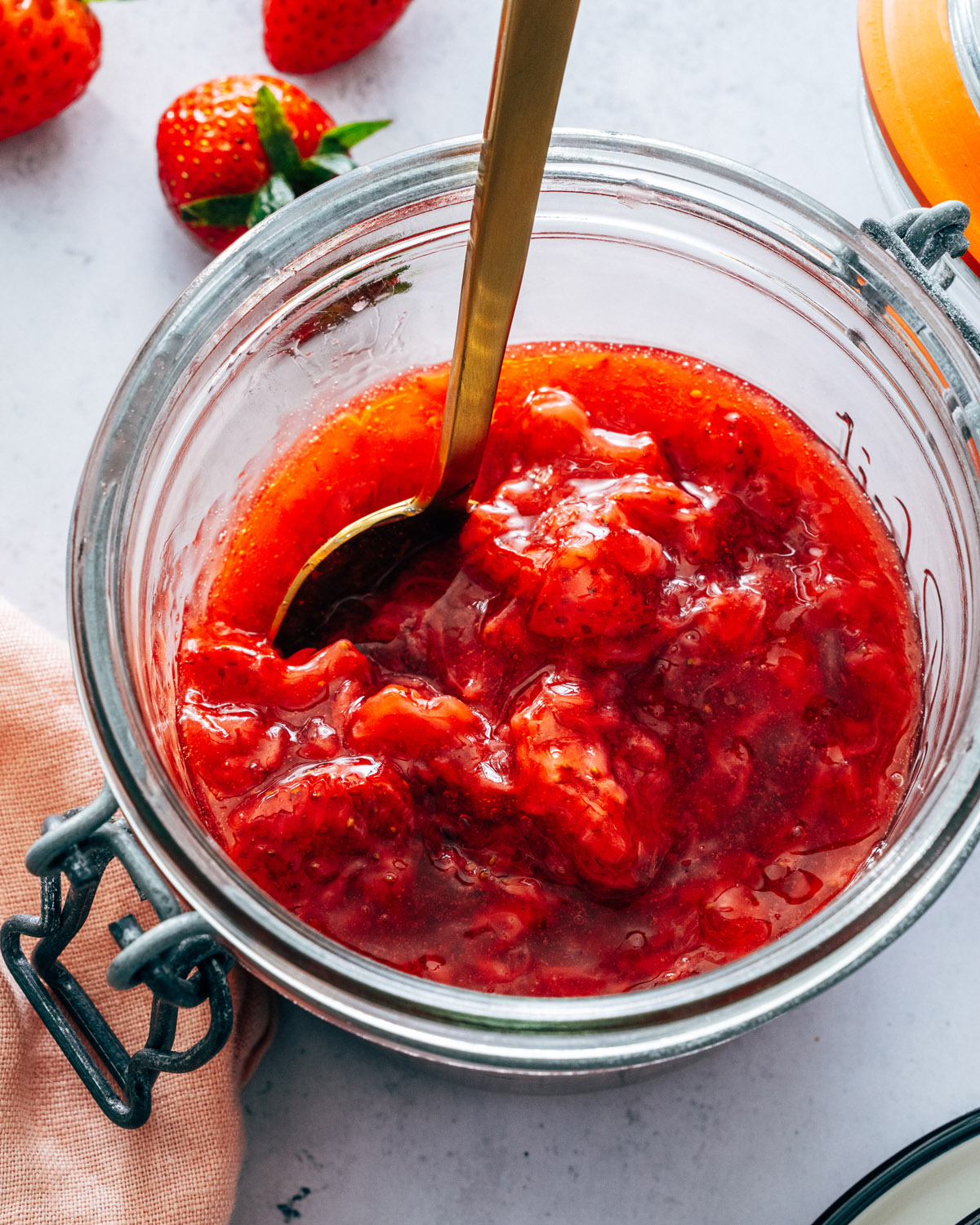 Strawberry Compote in a jar with spoon.