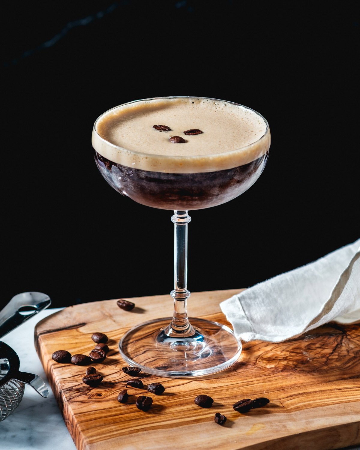 Espresso martini in cocktail glass with coffee beans