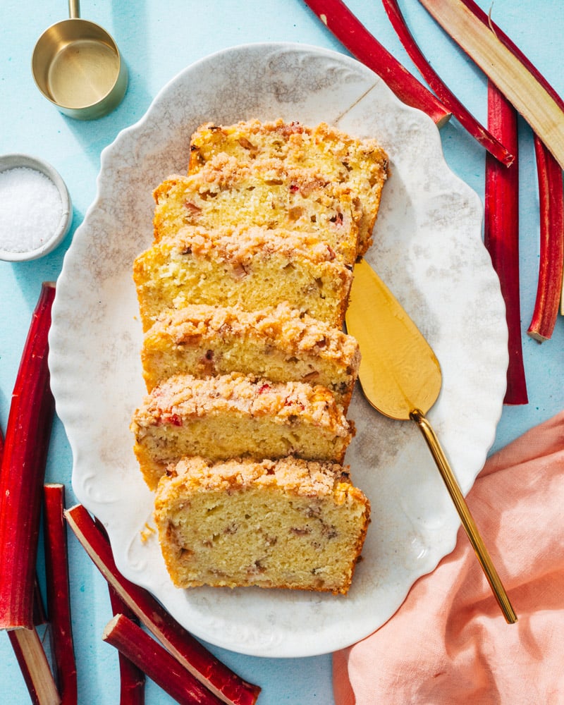 Rhubarb bread on platter with server. 