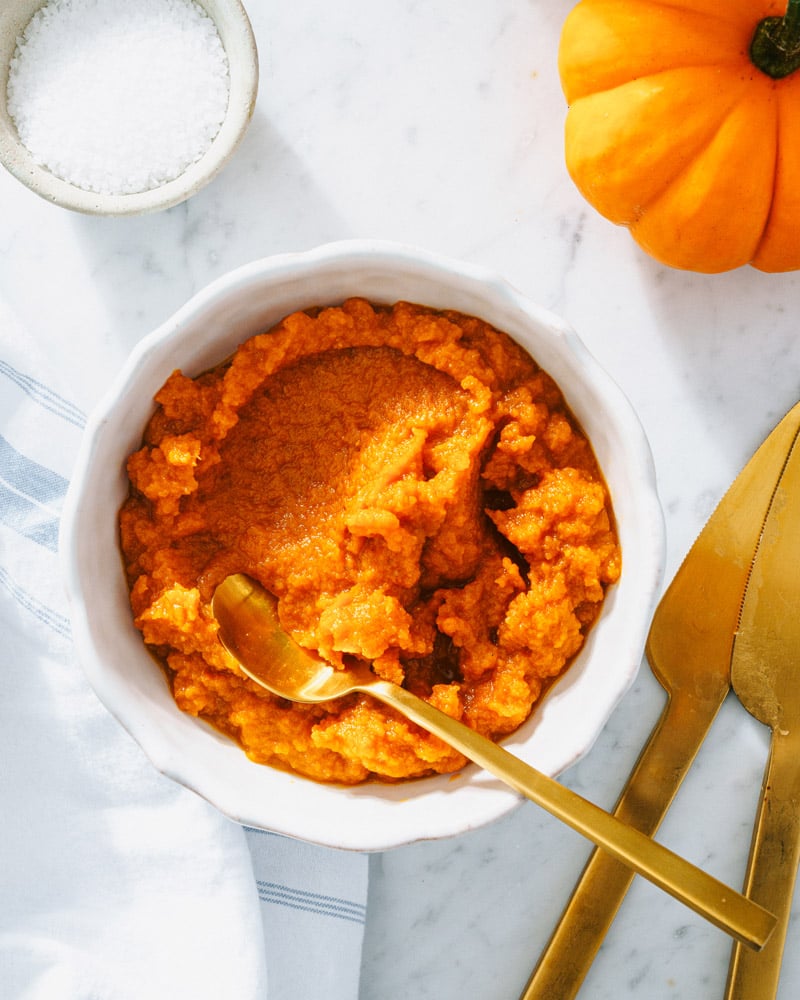 pumpkin puree in a bowl with spoon