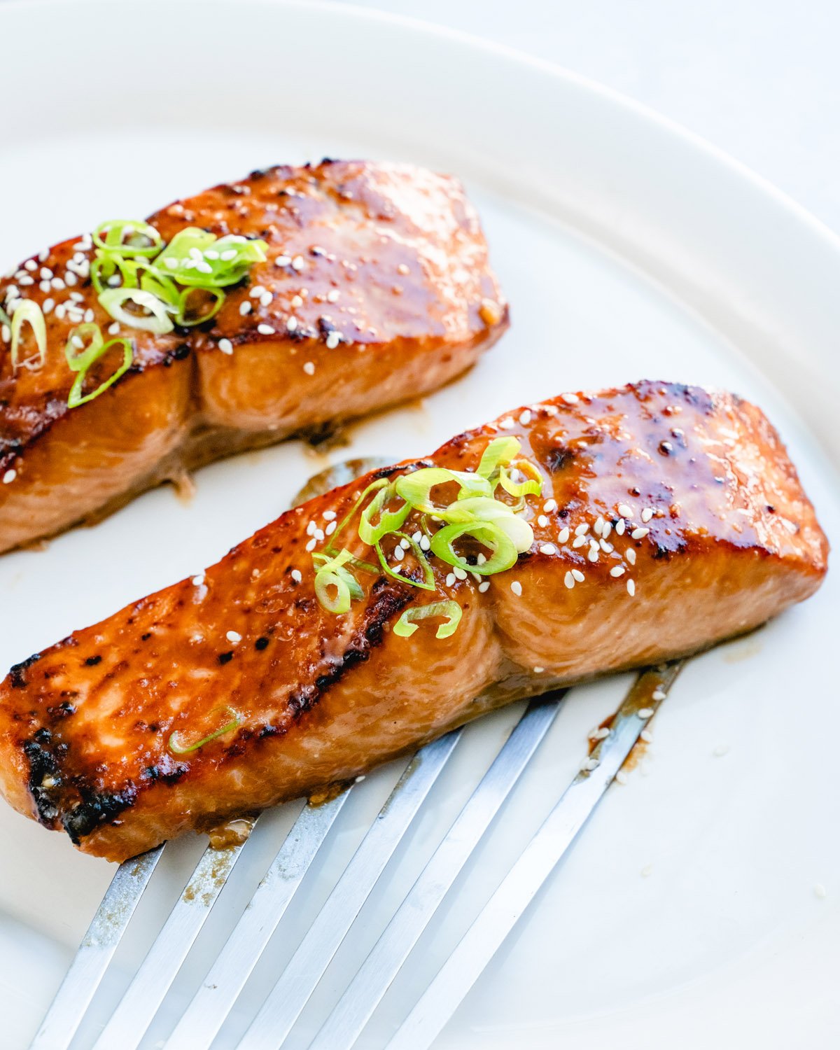 Miso salmon recipe with green onion garnish.