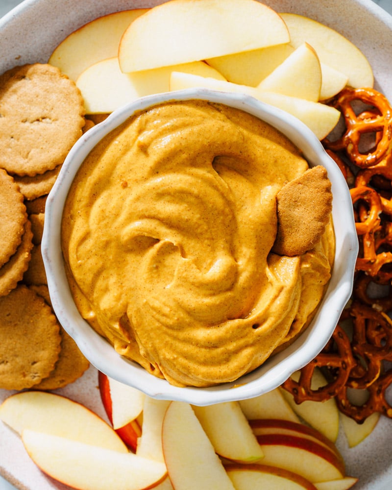 Pumpkin Dip on a platter with pretzels, apples and cookies