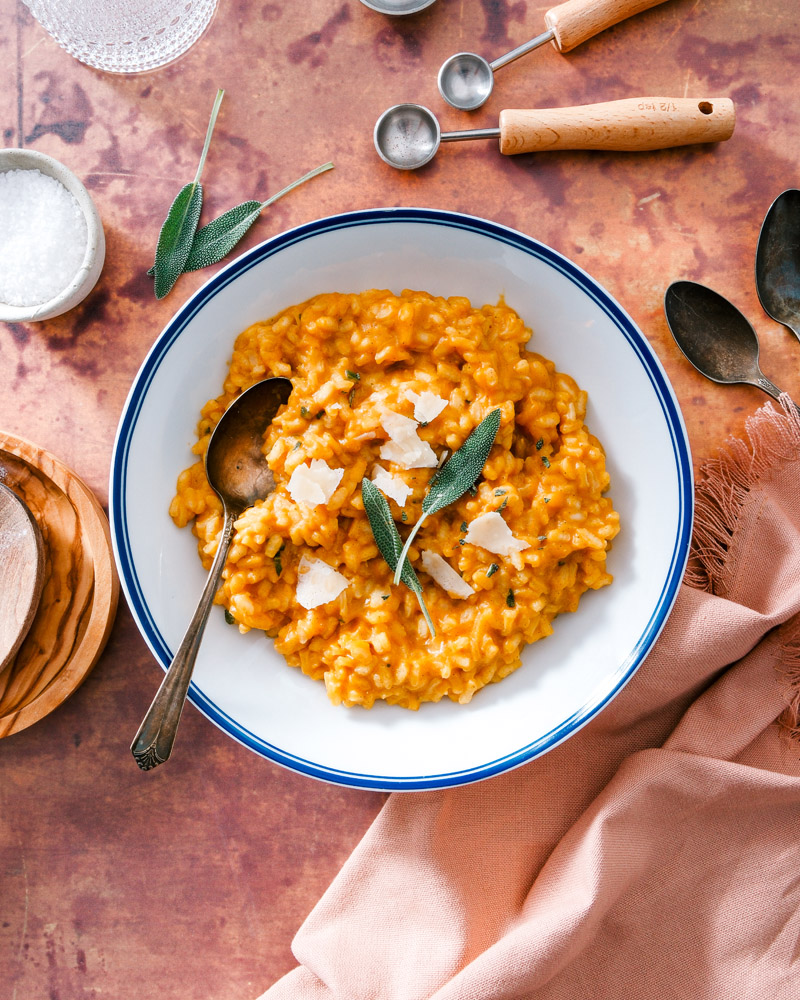 Pumpkin Risotto in bowl with Parmesan and sage garnish