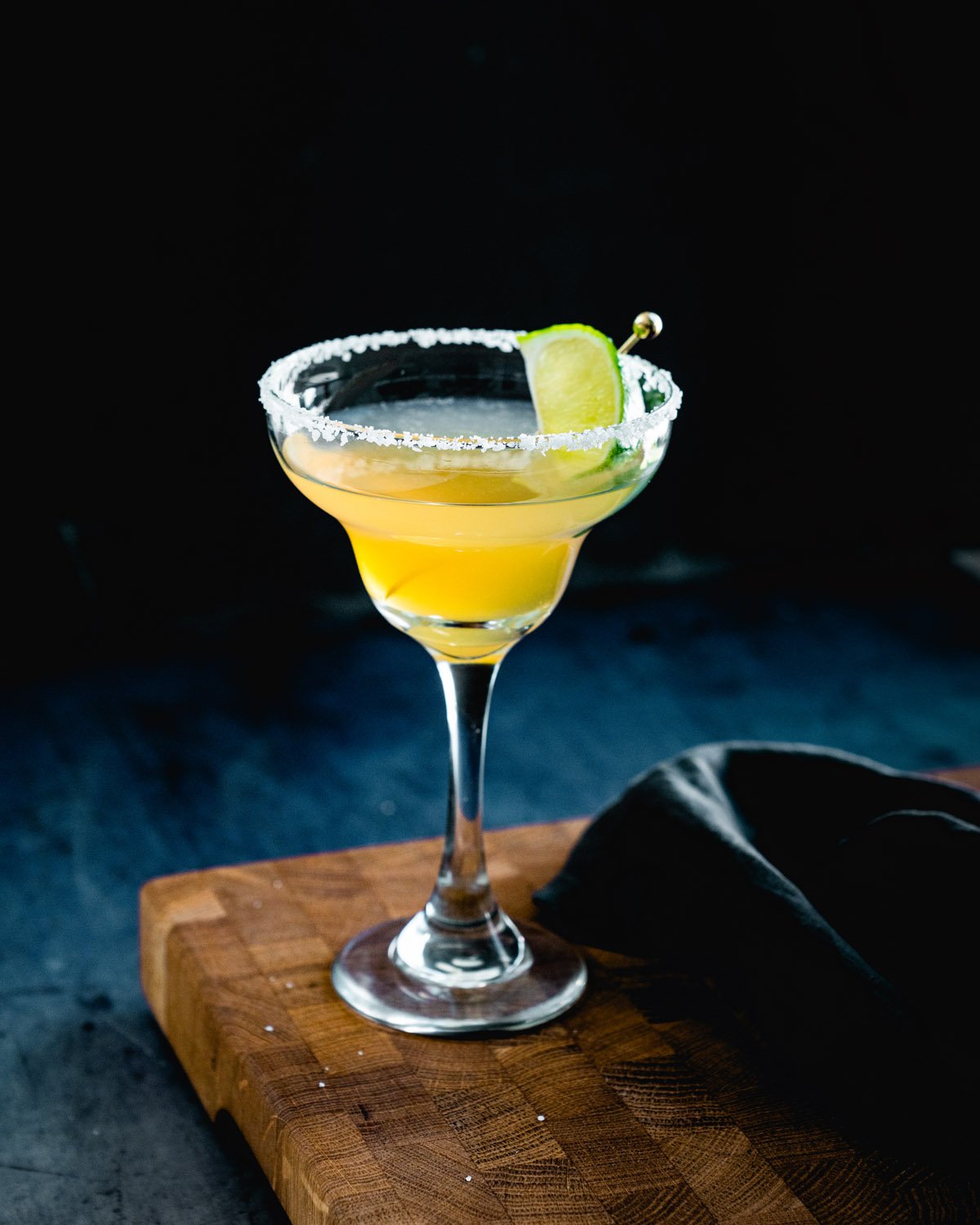 Cadillac margarita in margarita glass with salt rim.