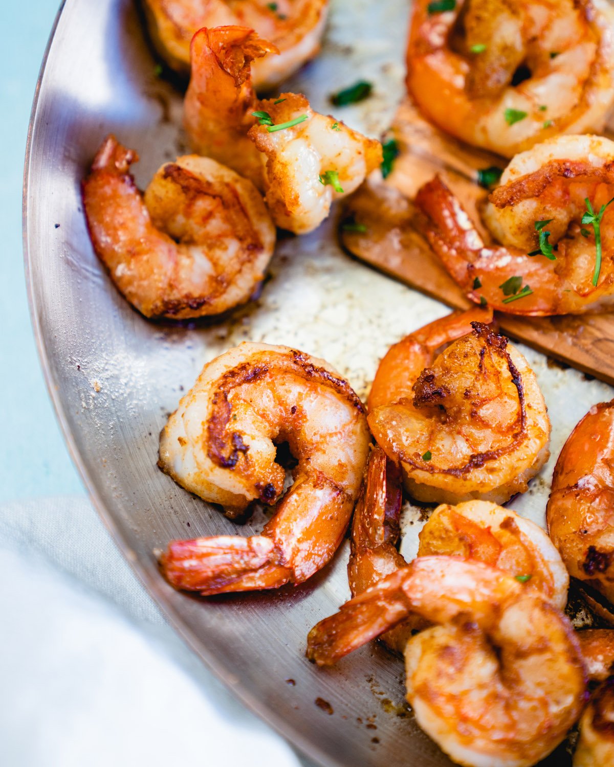 Overhead view of sautéed shrimp in a metal pan/