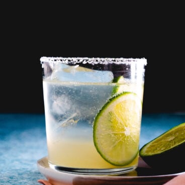 virgin margarita with lime garnishes and salt rim.