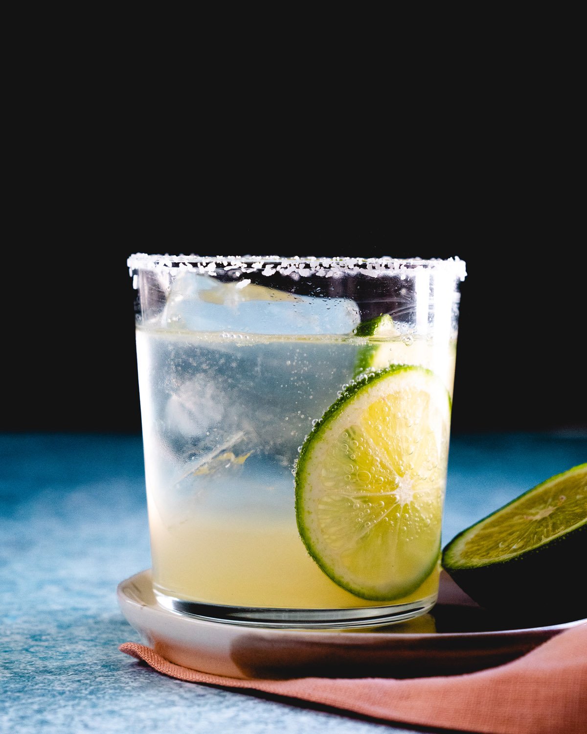 virgin margarita with lime garnishes and salt rim.