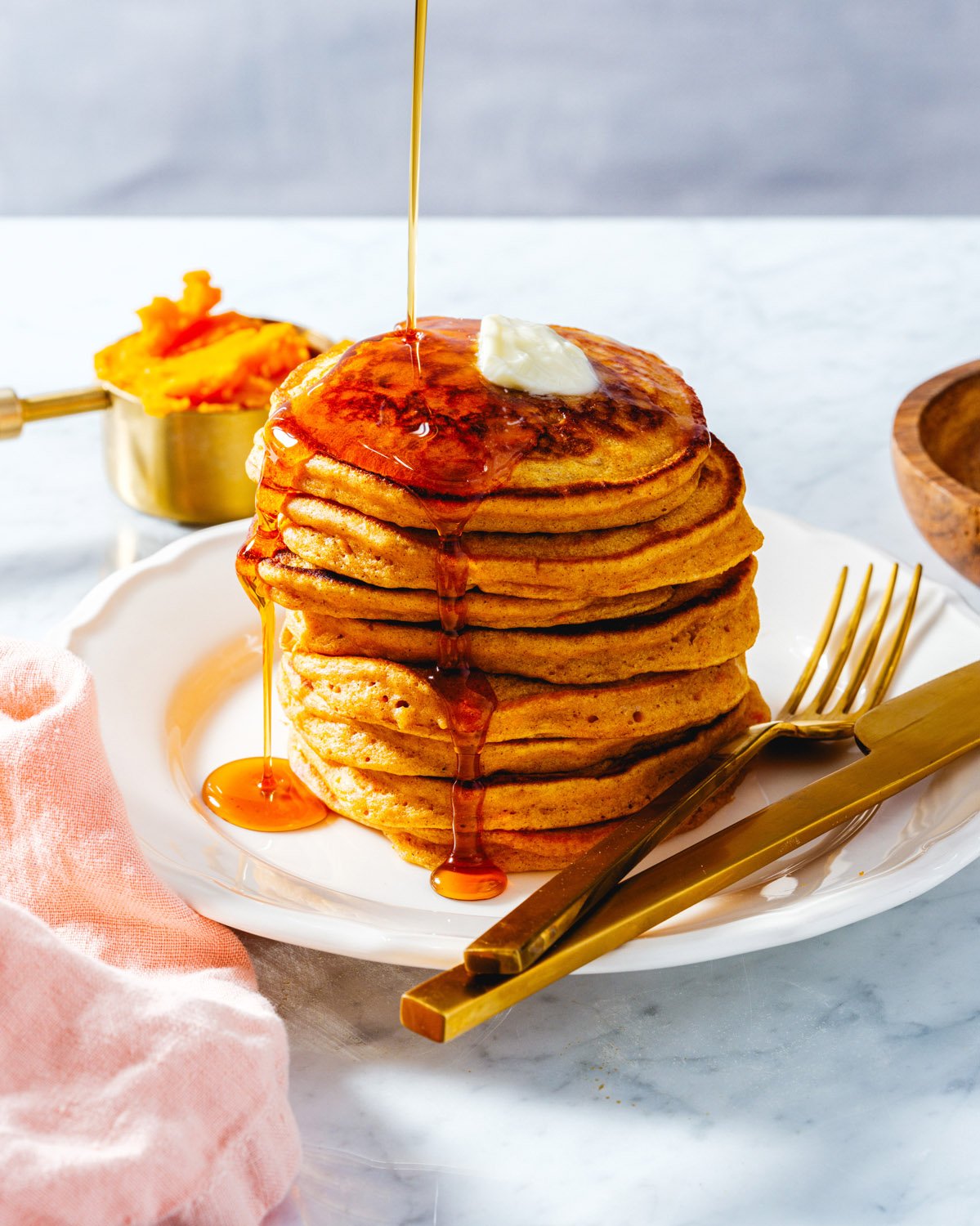 Sweet Potato Pancakes with syrup pouring over