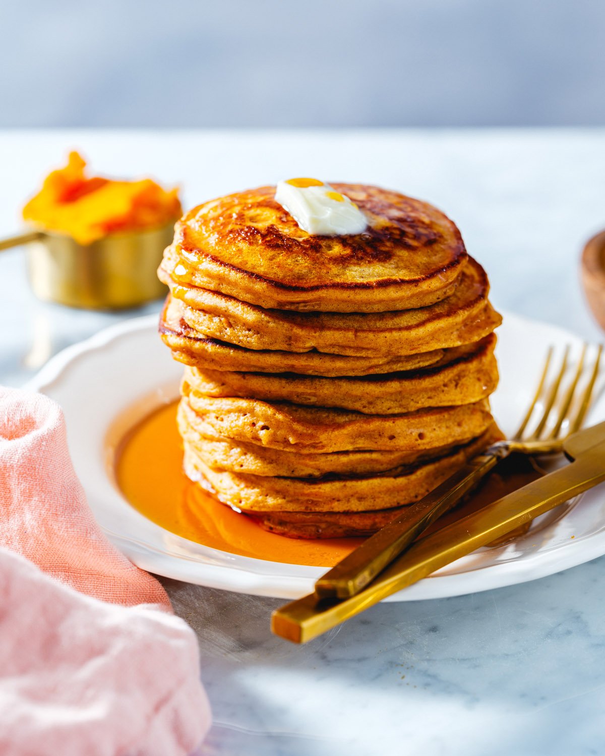 Sweet potato pancakes in a stack with syrup