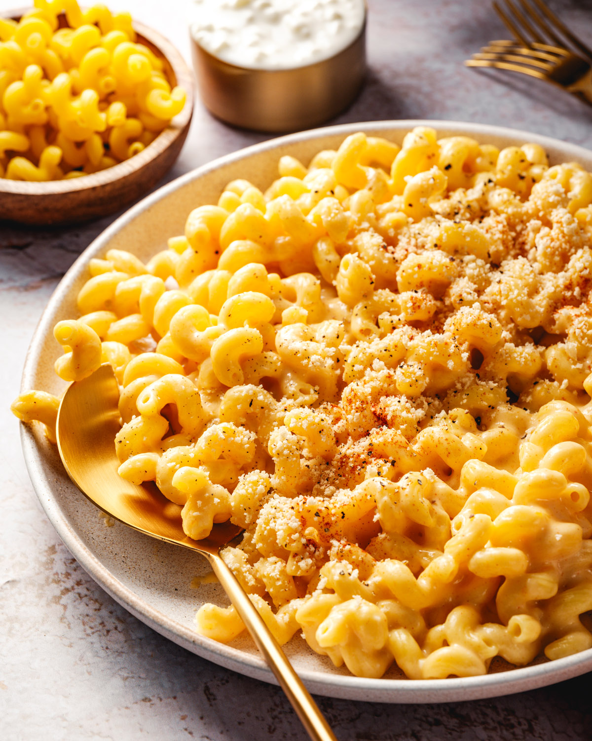 Cottage cheese mac and cheese in a bowl with serving spoon.