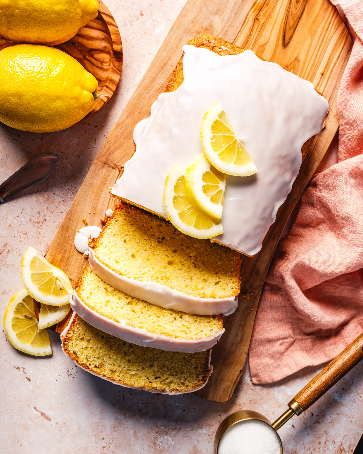 Overhead shot of lemon bread recipe with glaze and lemon slices.