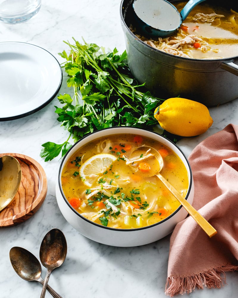 Chicken orzo soup in bowl with pot