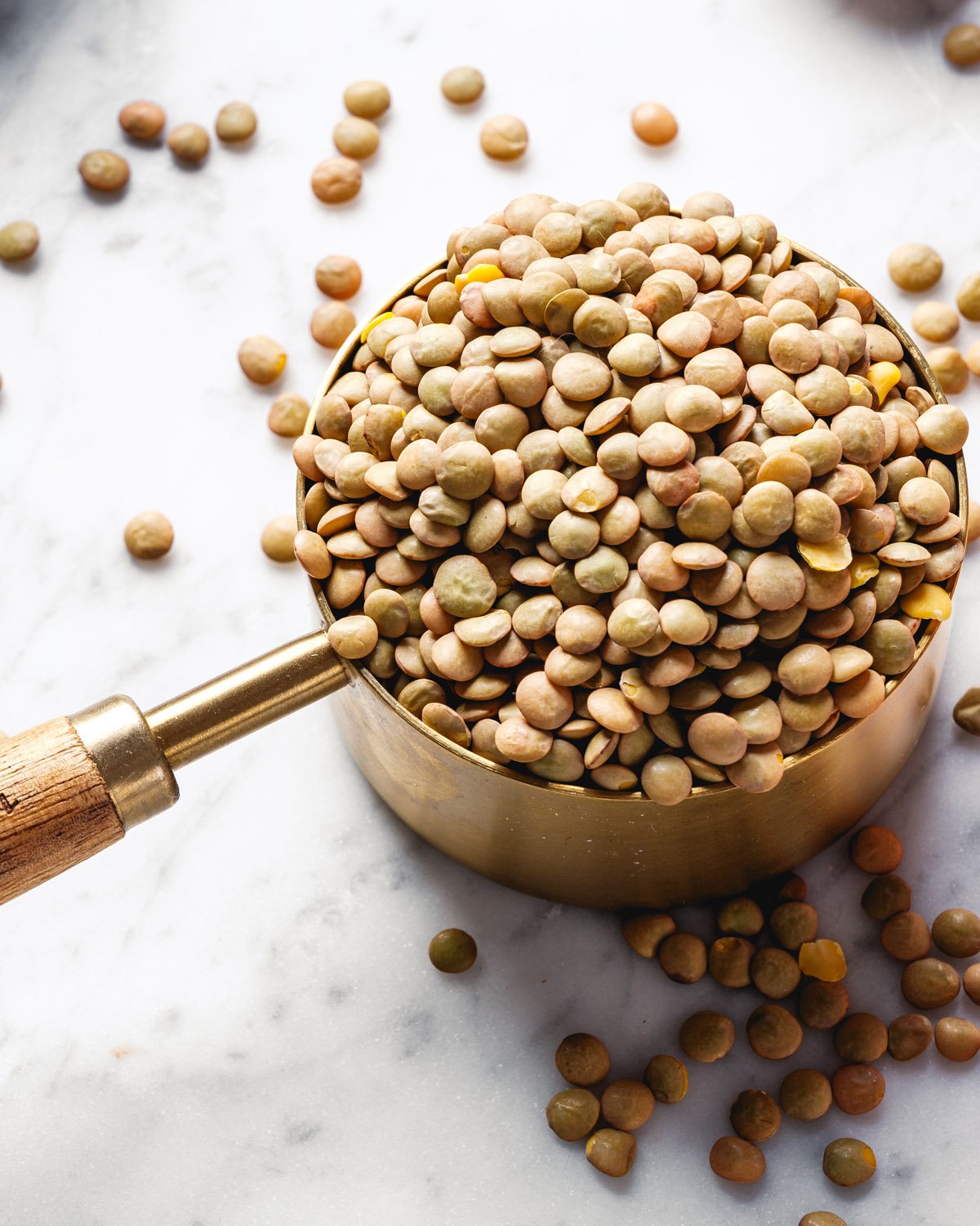 Measuring cup with green lentils.