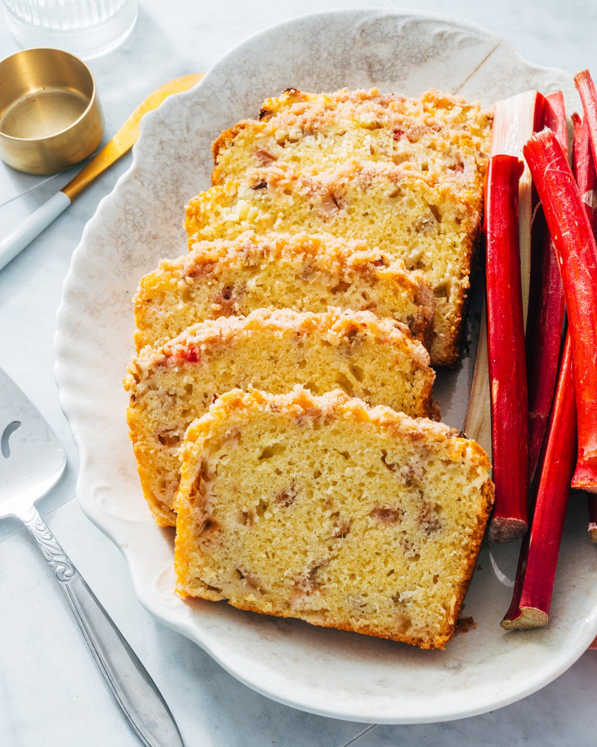 Rhubarb Bread with rhubarb stalks on platter.