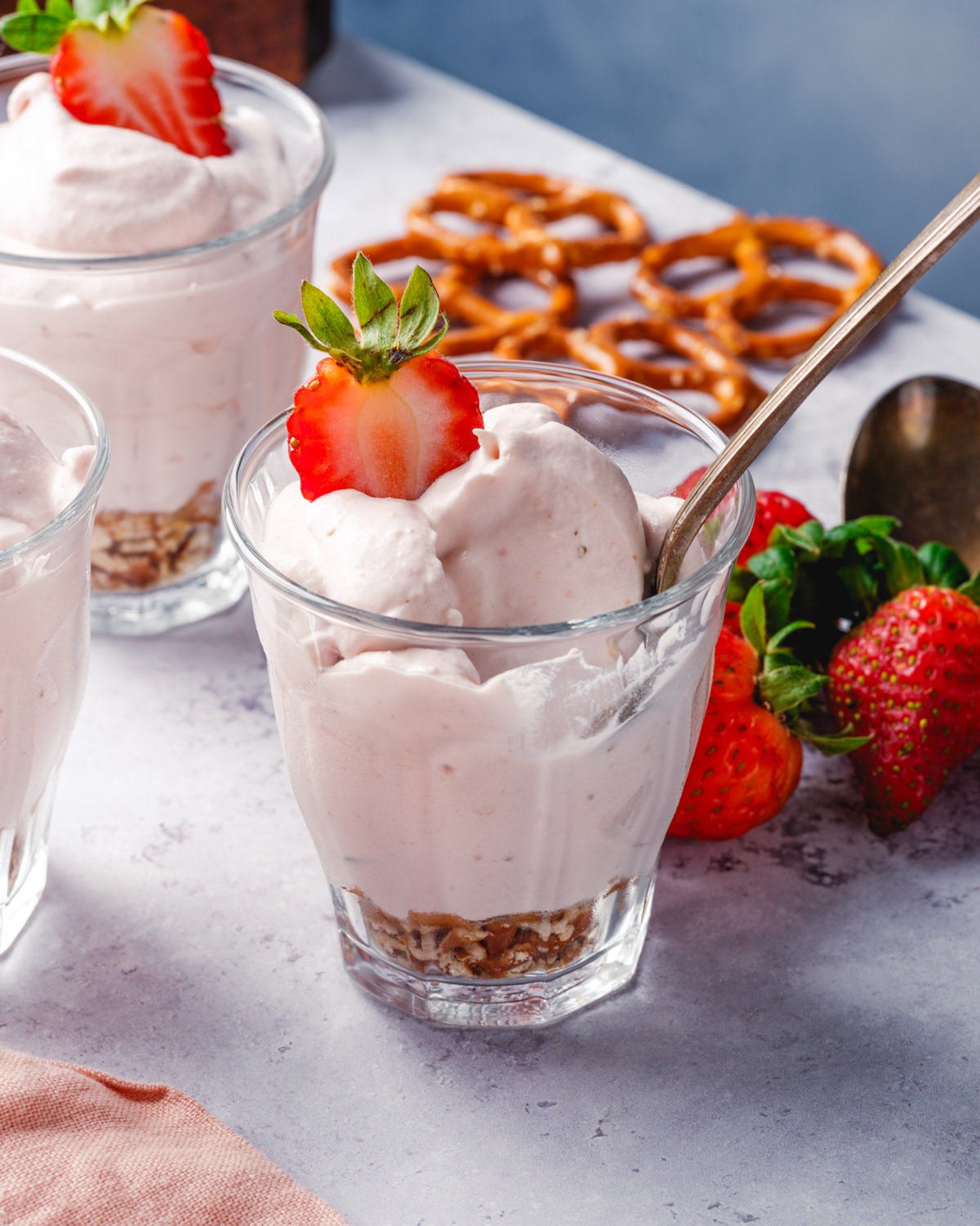 Strawberry Mousse in cup with spoon and strawberry garnish.