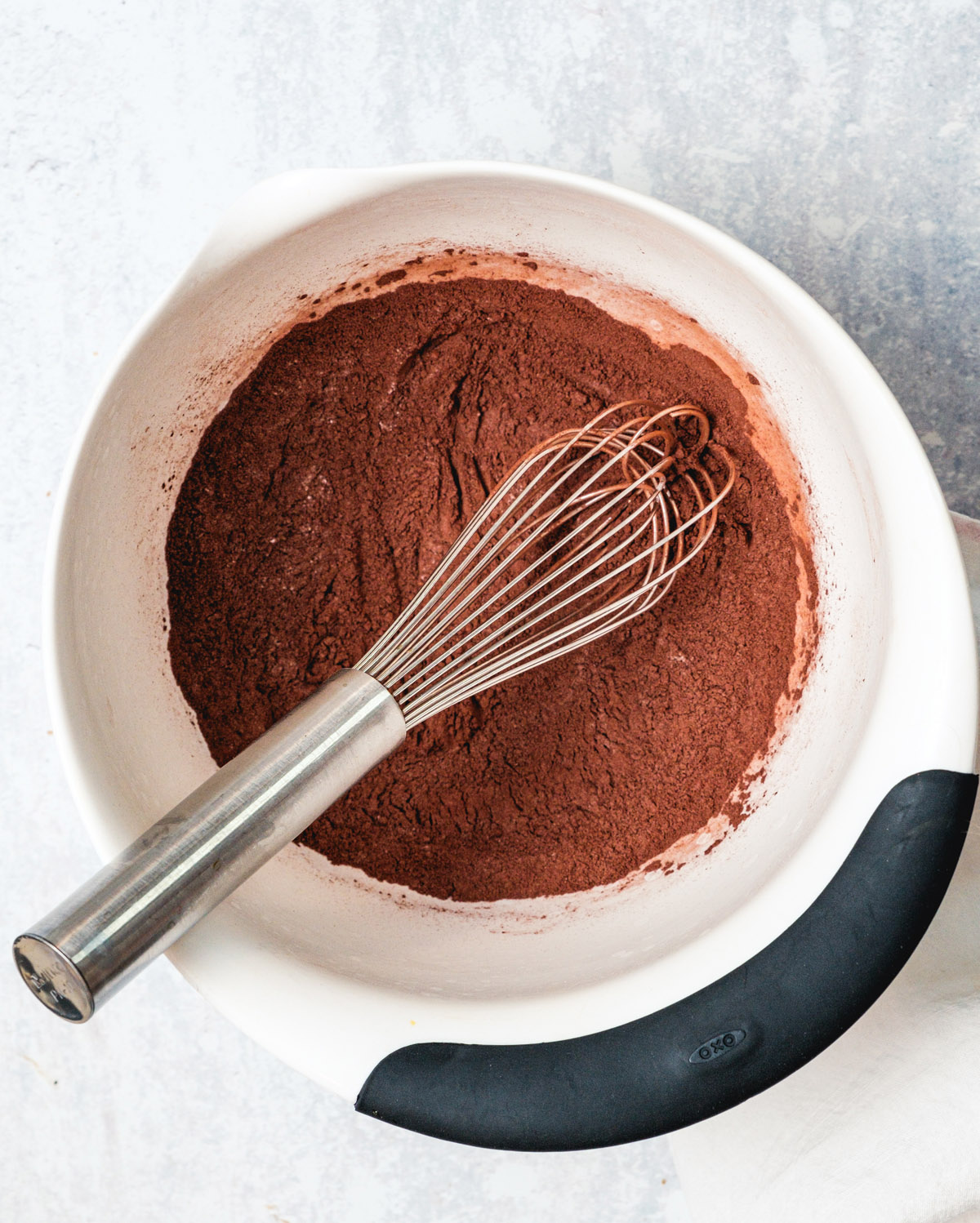 Bowl with whisk and cocoa powder flour and salt.
