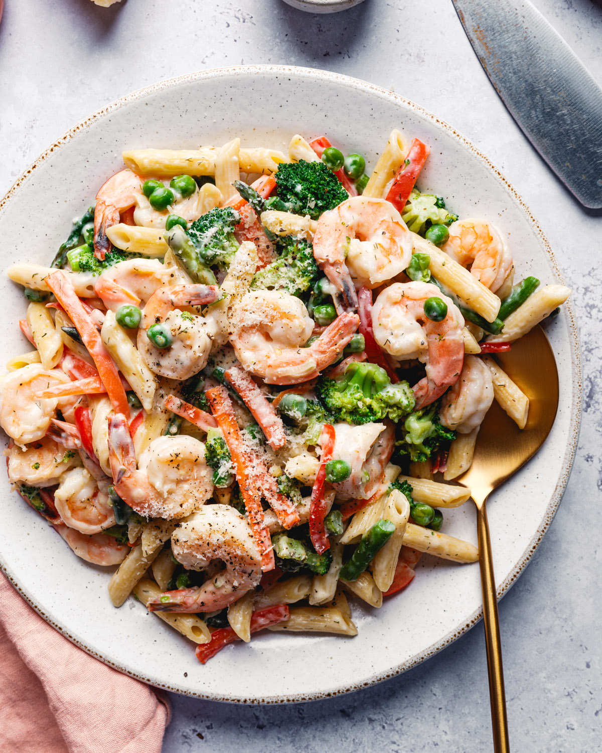 Shrimp Primavera in bowl with colorful vegetables and creamy sauce.