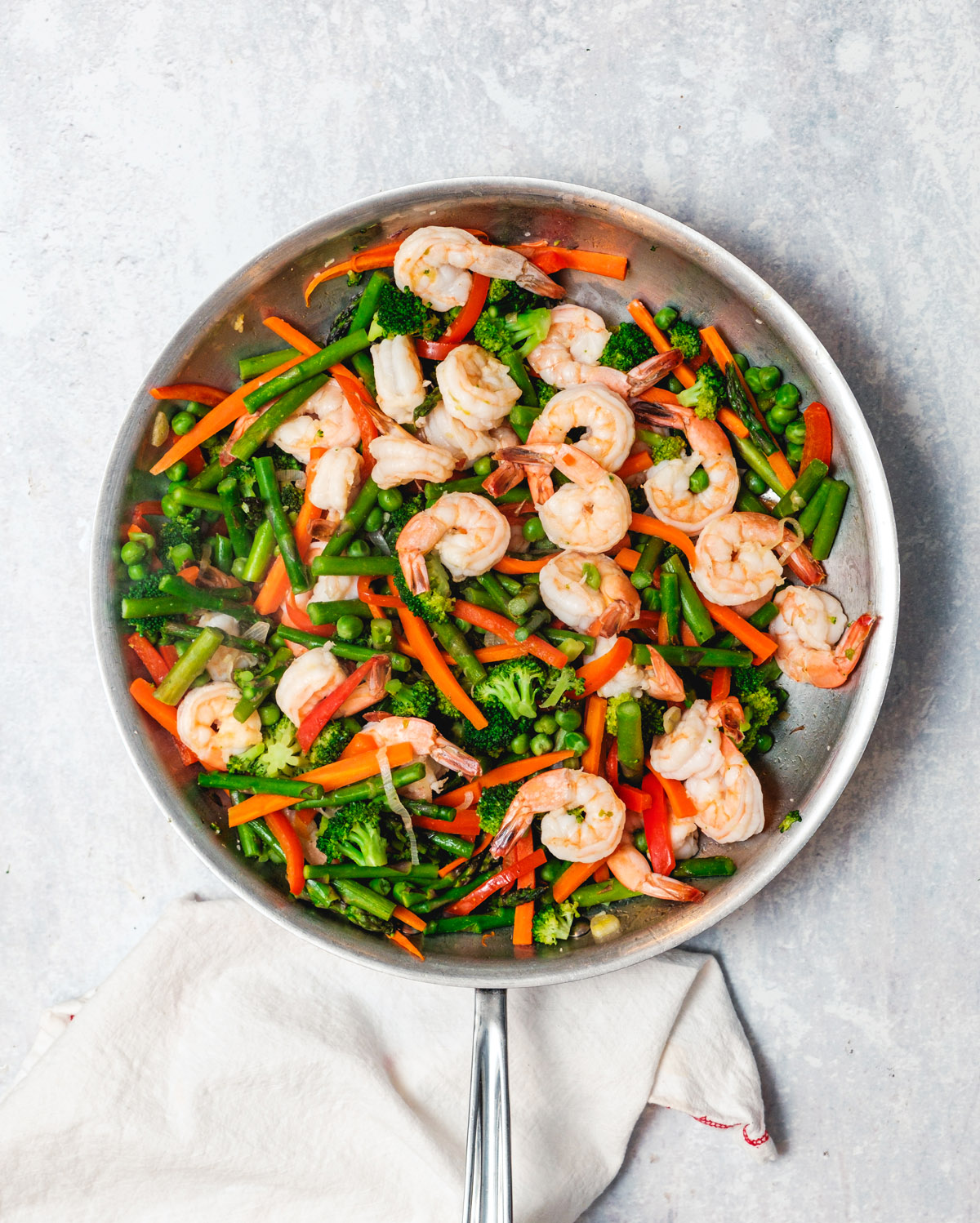 Shrimp primavera step 2: Shrimp and peas in skillet with vegetables.